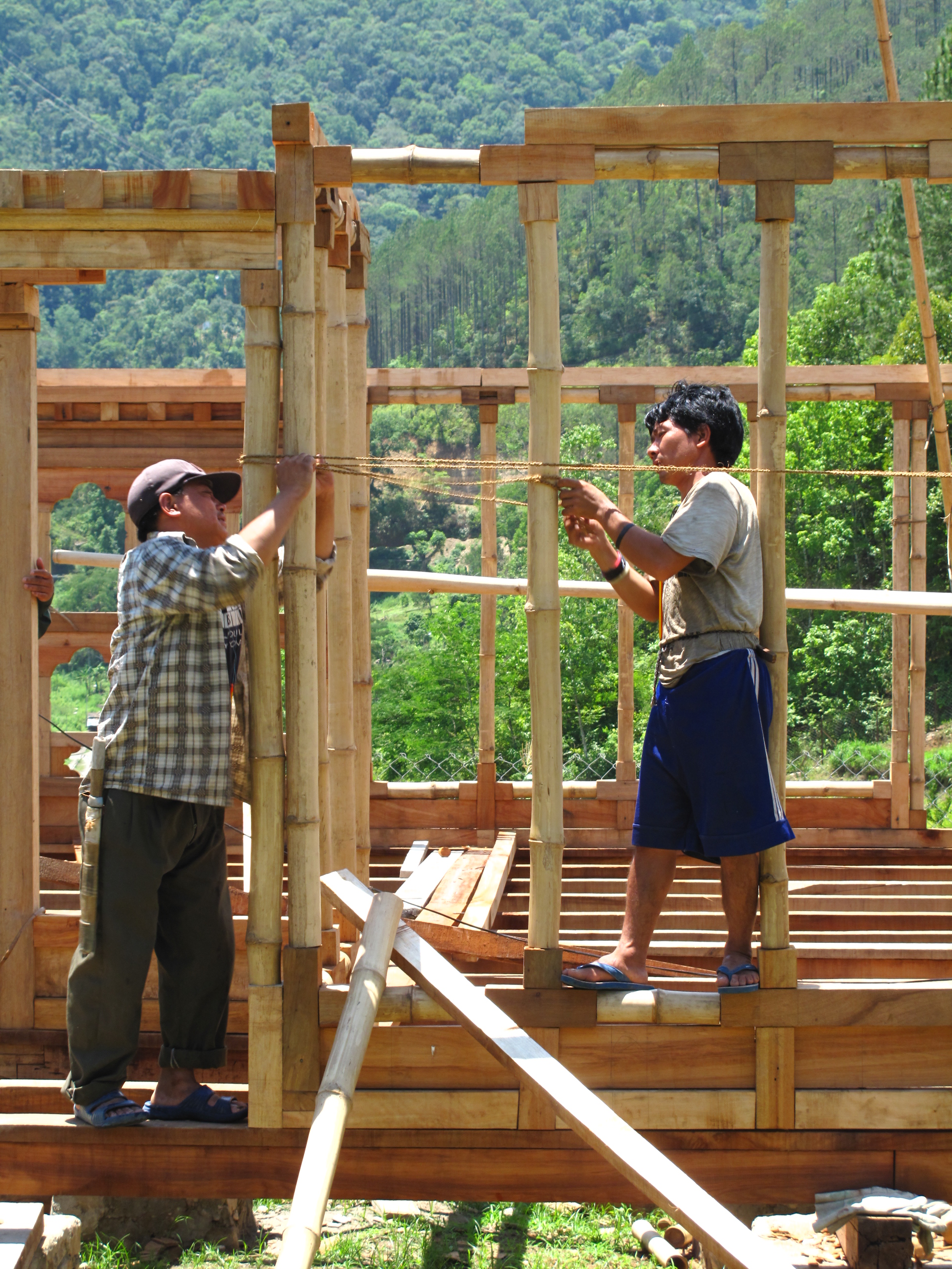 House construction with round bamboo poles in Bhutan